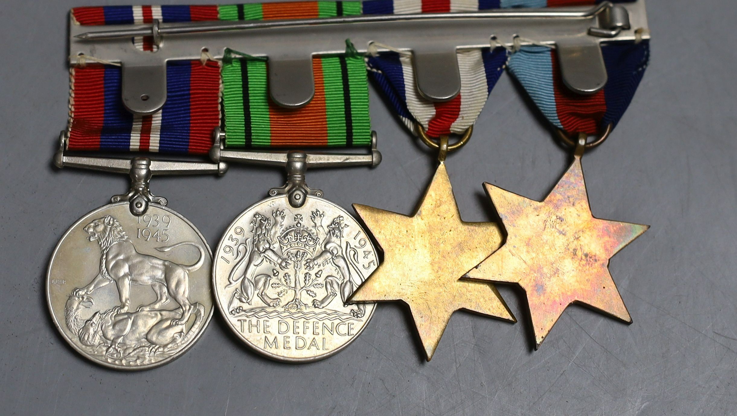 A group of five WW2 medals, together with a selection of cap badges and a GS Mk.II pocket watch